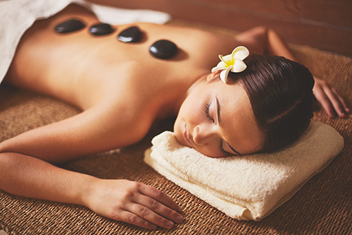 Portrait of young female lying in spa salon during beauty procedure